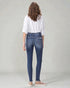 Person wearing blue jeans and a white shirt on a plain background