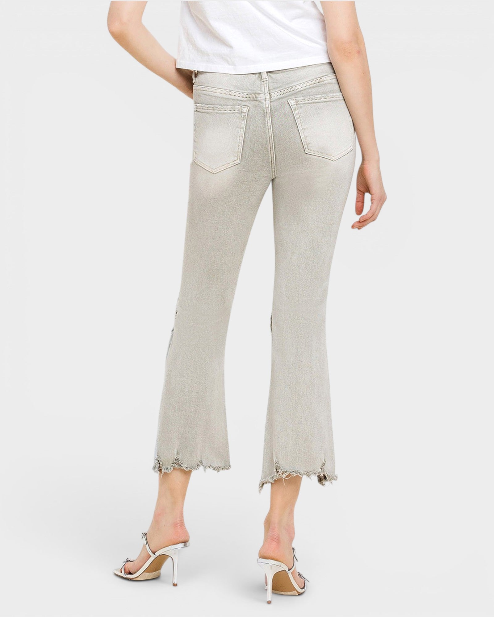 Light gray jeans worn by a person on a white background