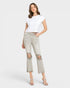 Woman wearing a white t-shirt and light gray distressed jeans on a white background