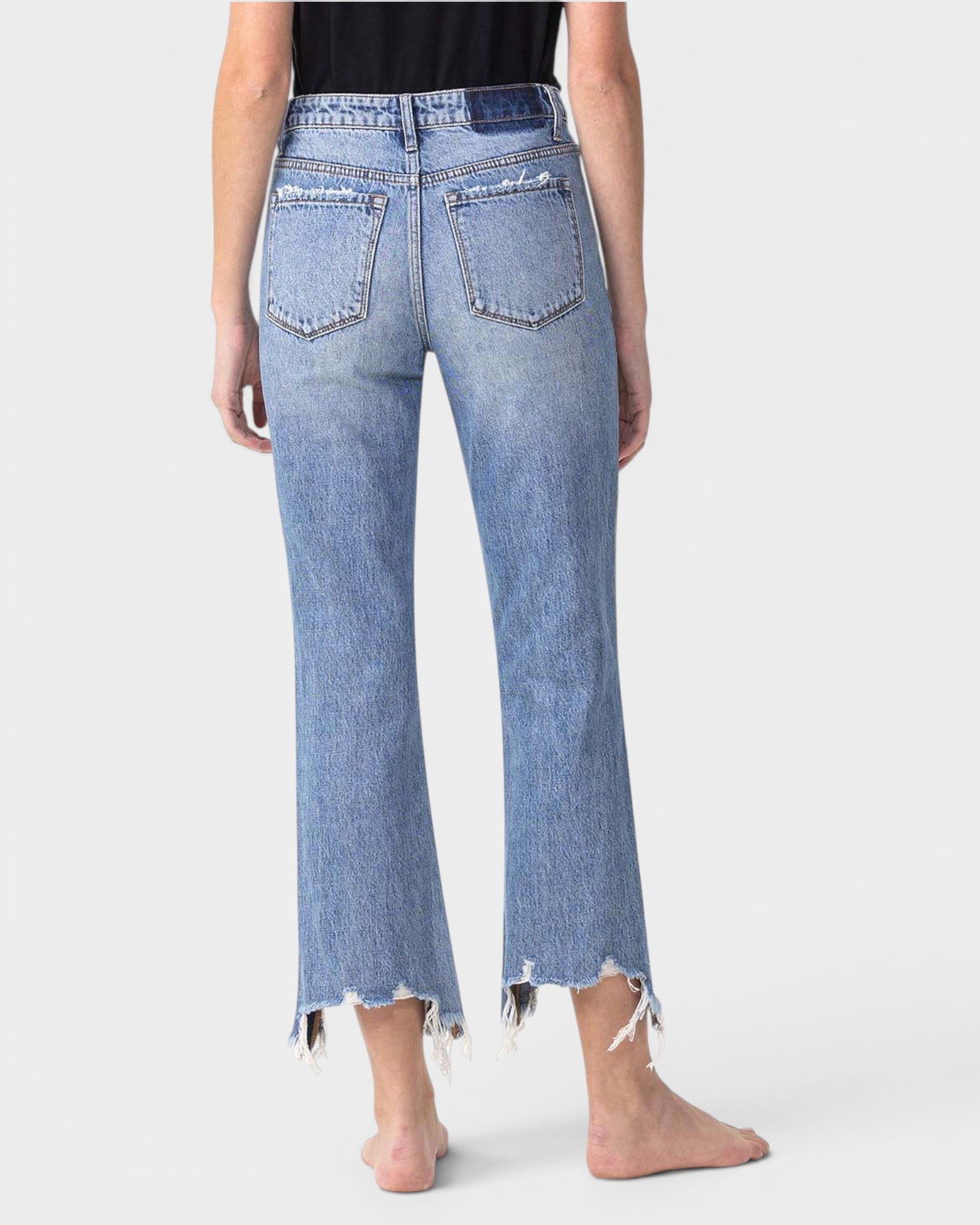 Light blue jeans worn by a person on a white background