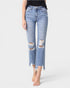 Ripped blue jeans worn by a person on a white background