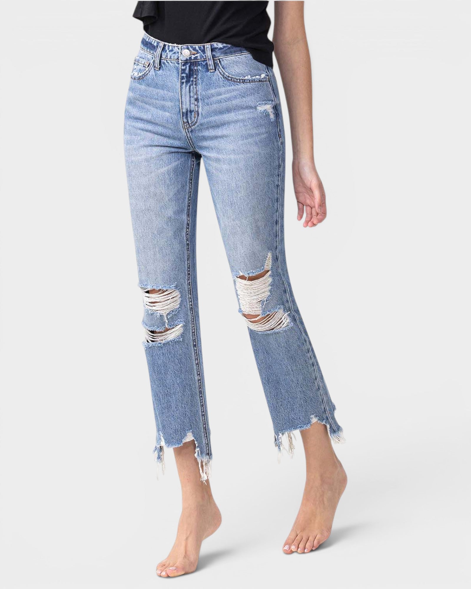 Light blue distressed jeans worn by a person on a white background
