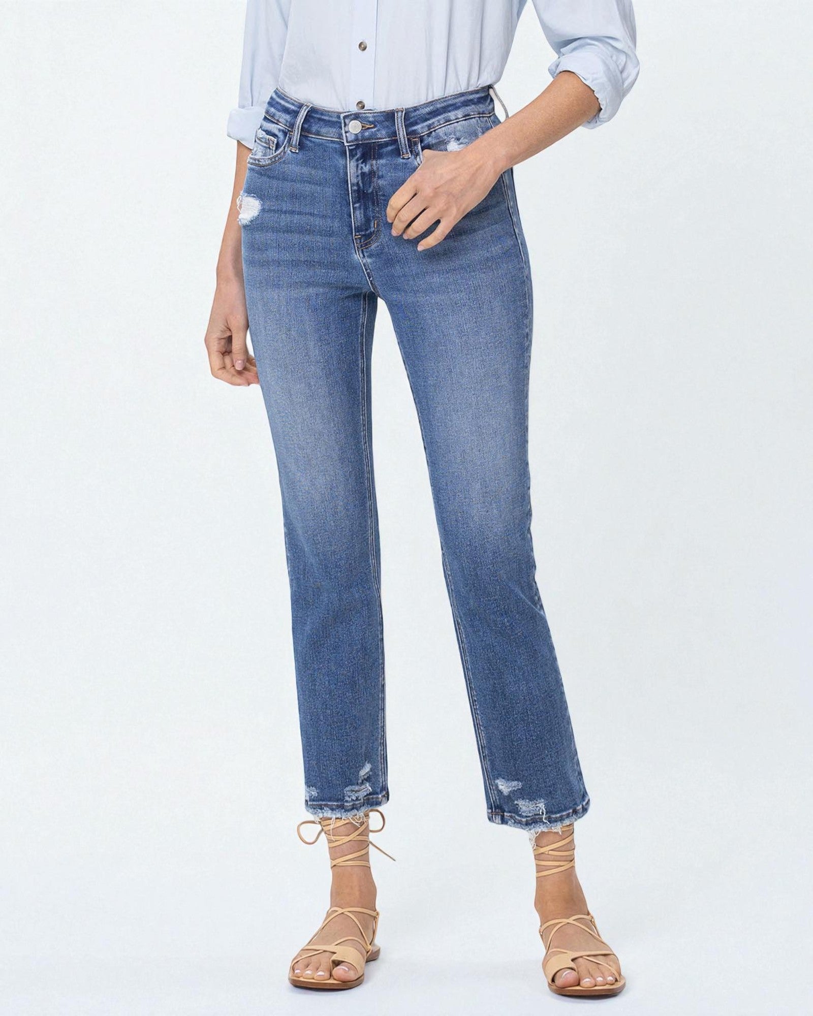 Person wearing blue jeans and a light blue shirt on a white background