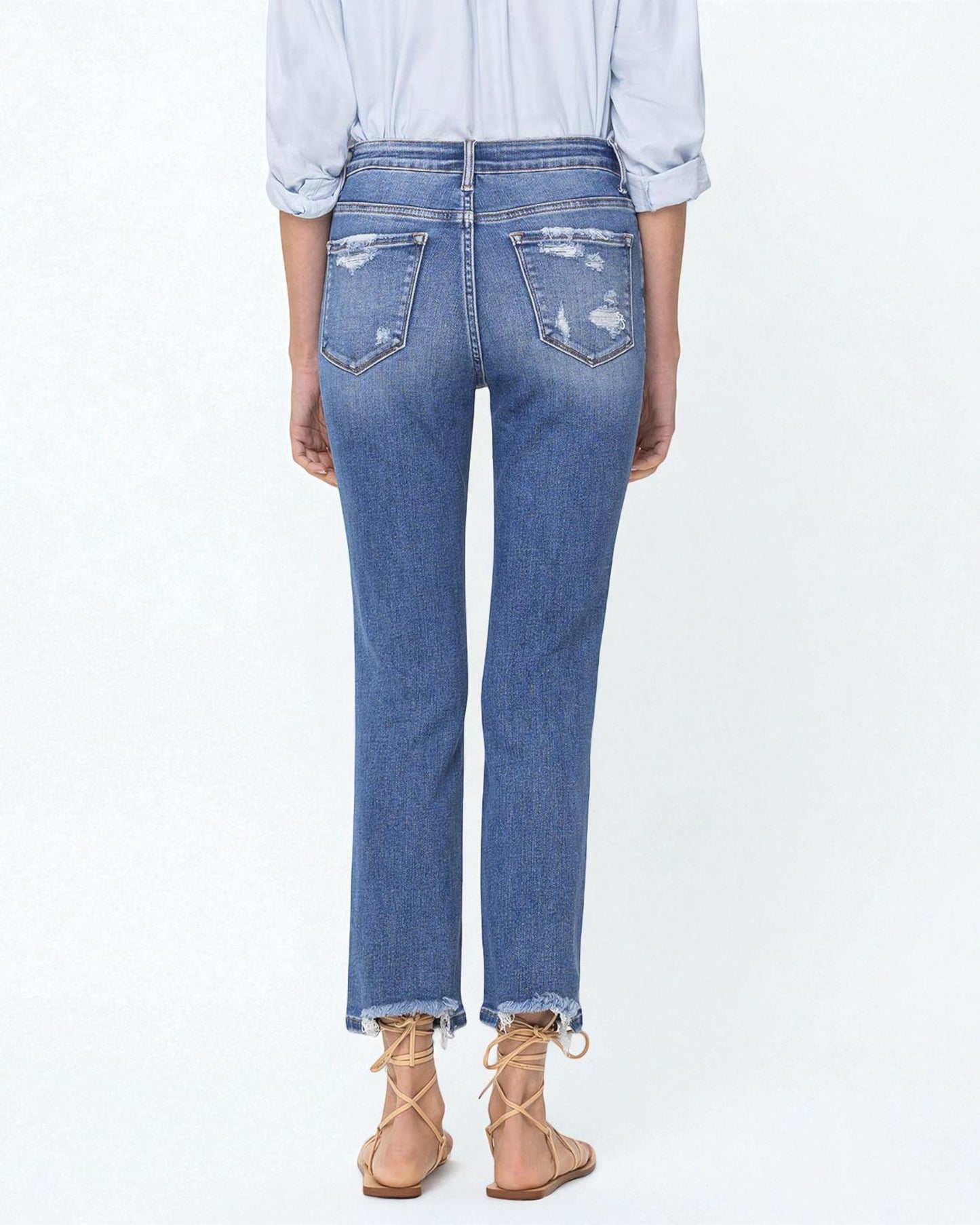 Person wearing blue jeans with a white background