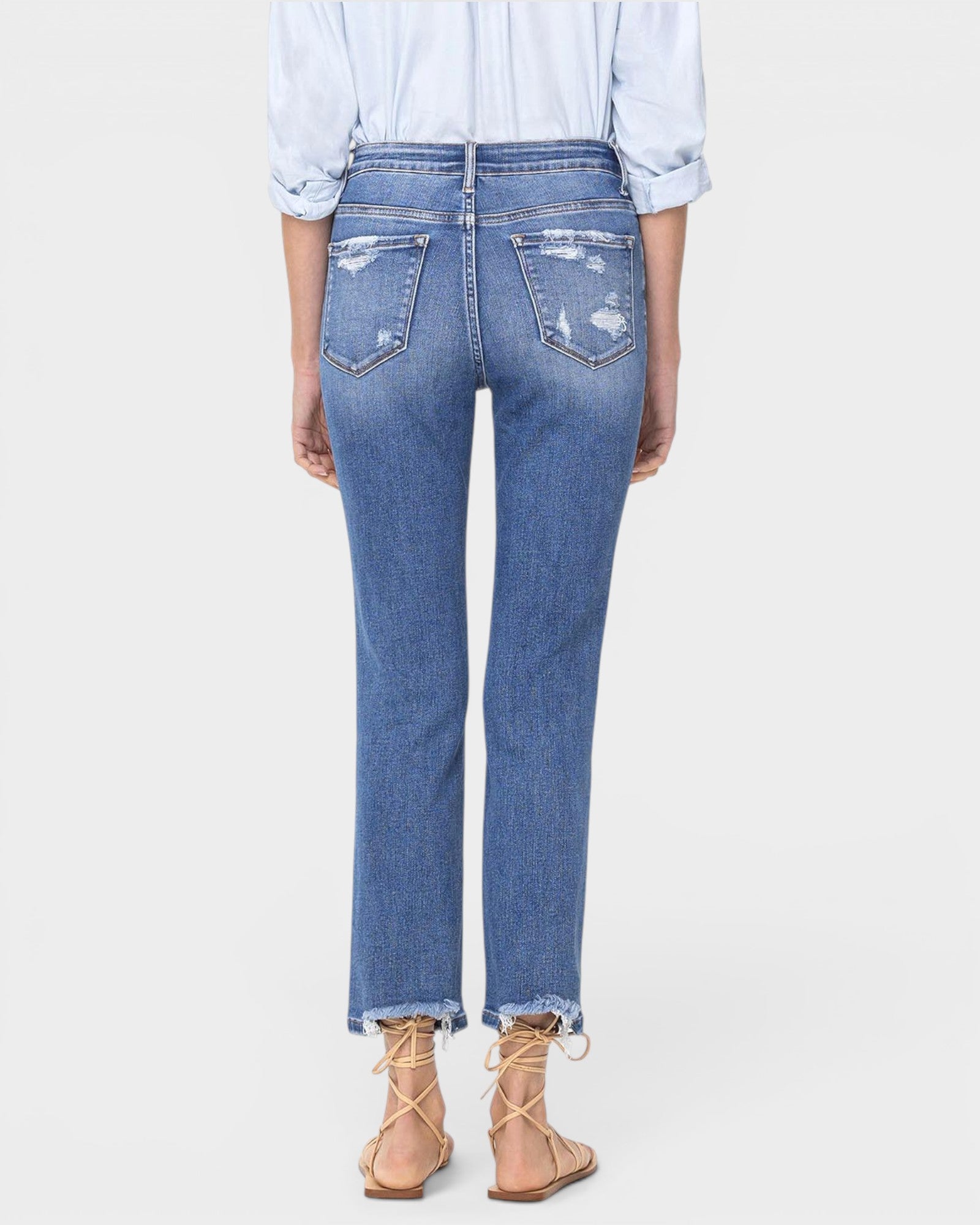 Person wearing blue jeans on a white background