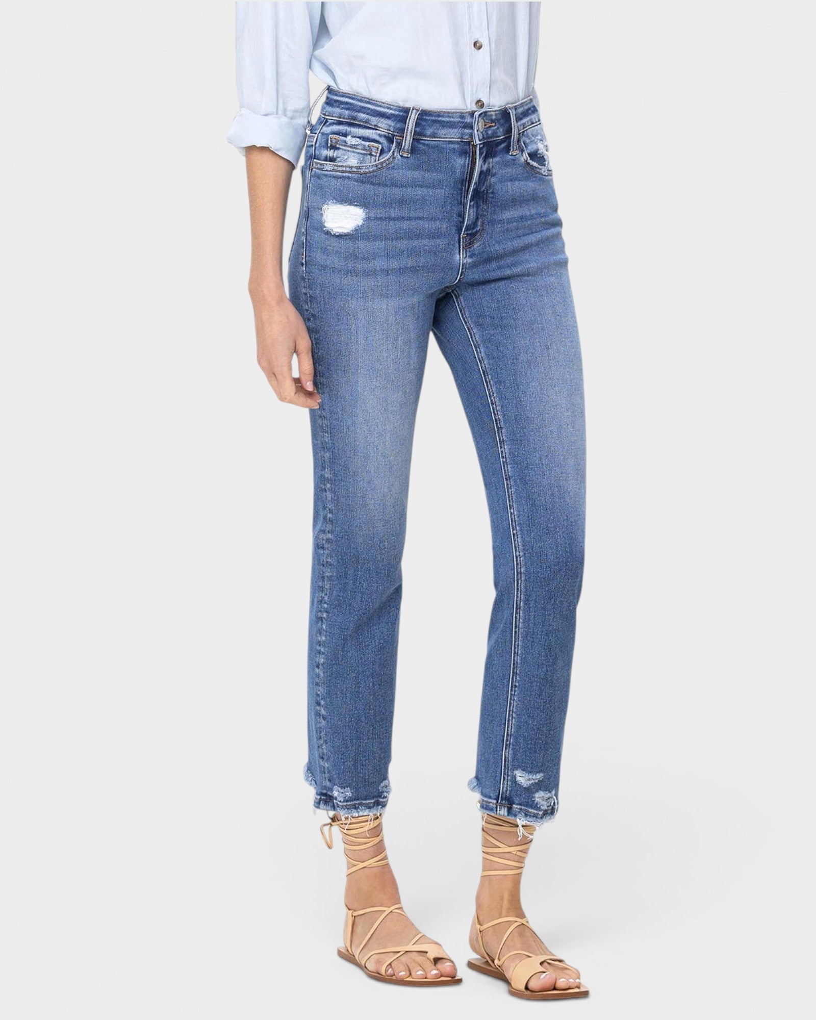 Blue jeans worn by a person on a white background