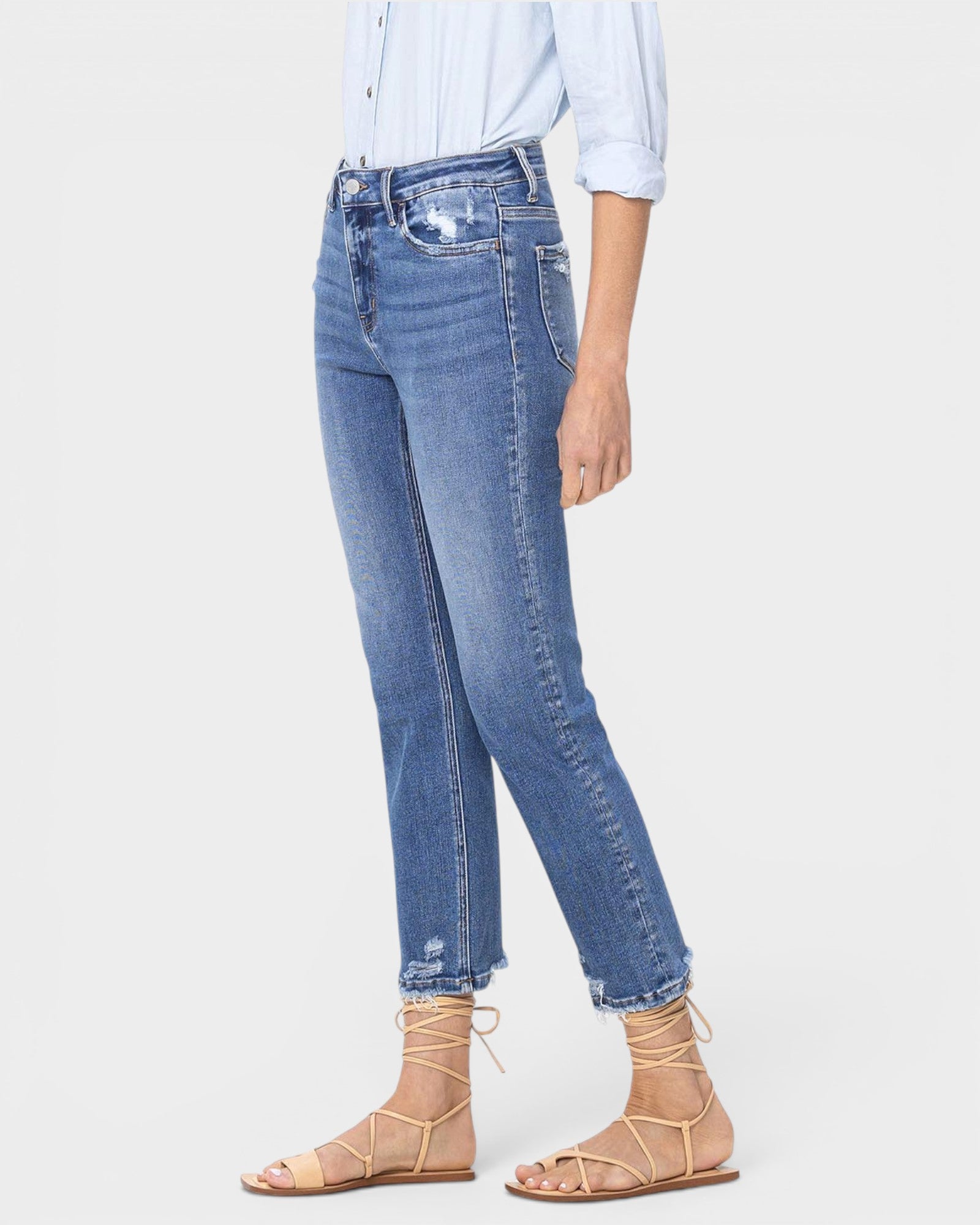 Person wearing blue jeans and a light blue shirt on a white background