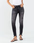 Person wearing black distressed jeans on a white background