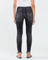 Person wearing black denim jeans on a white background