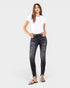 Woman wearing black jeans and a white t-shirt on a white background