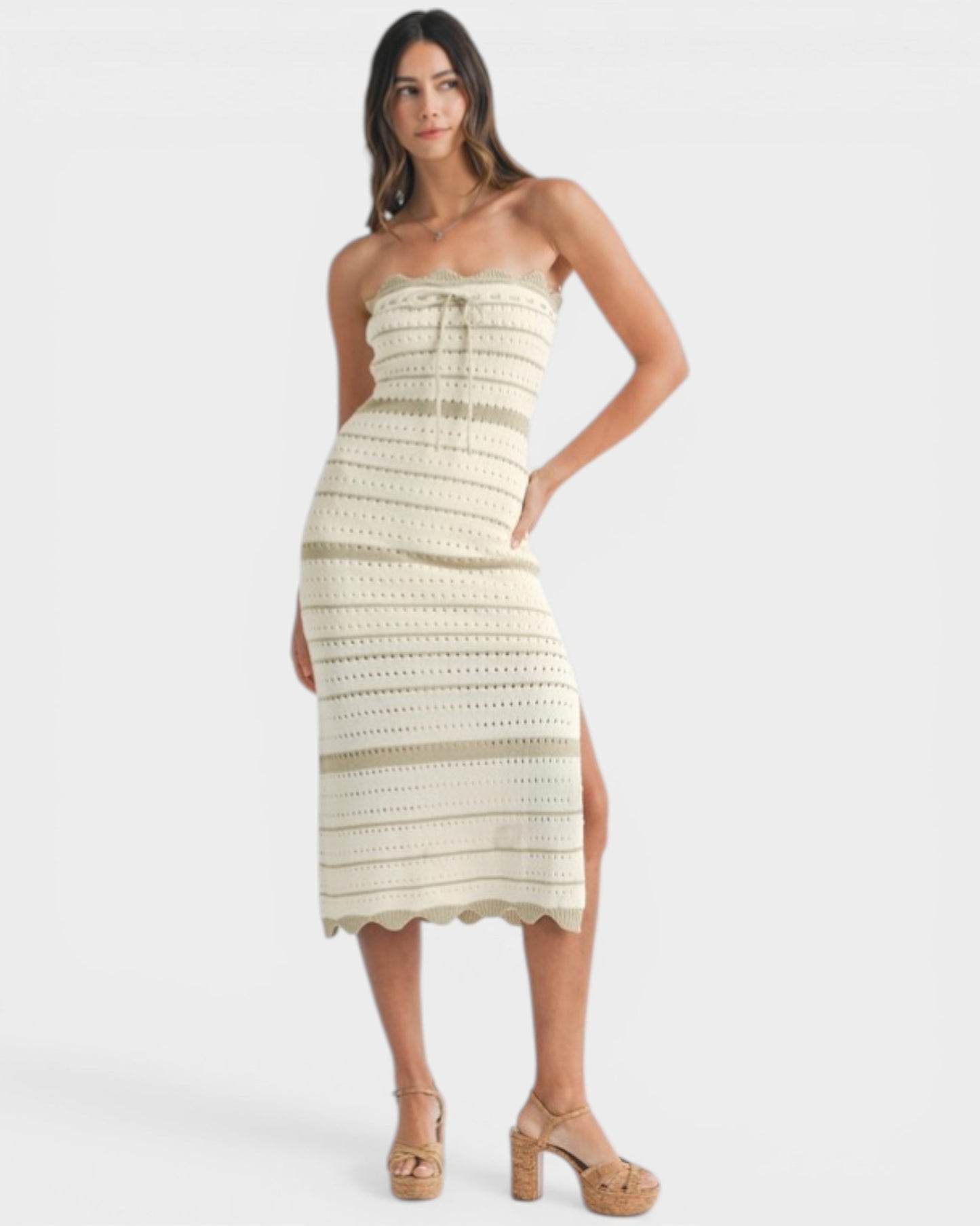 Woman wearing a strapless, patterned dress on a white background