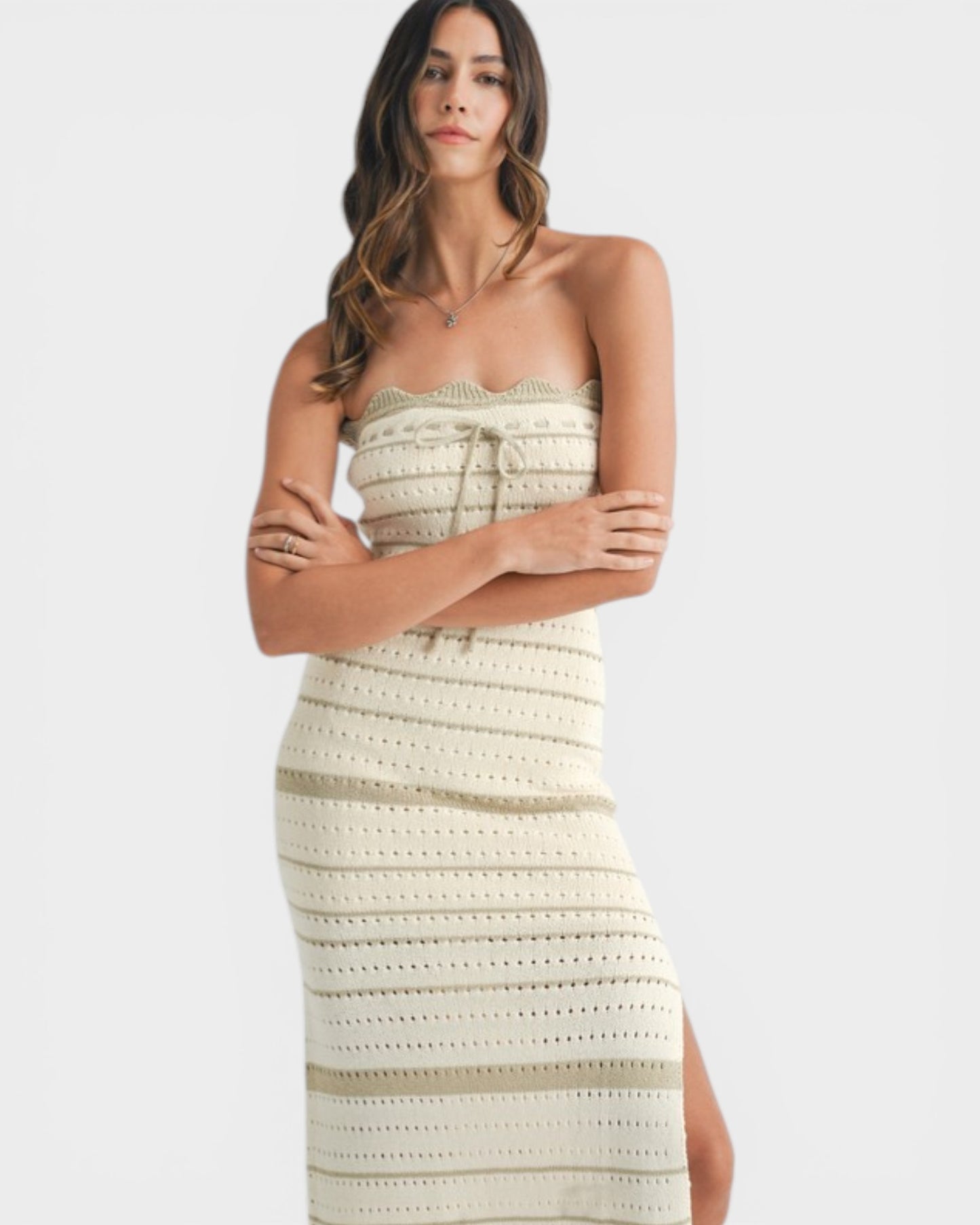 Woman wearing a strapless crochet dress on a white background