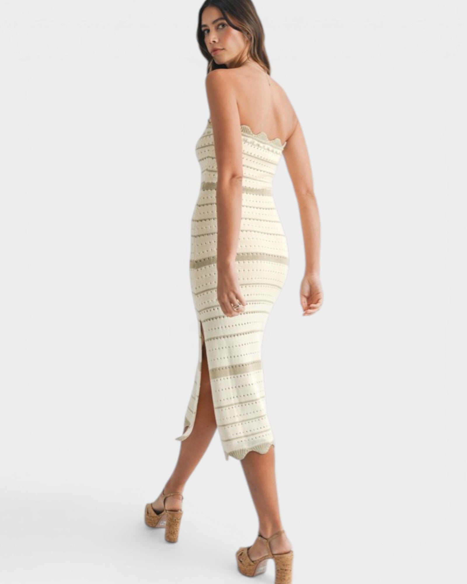 Woman wearing a strapless, patterned dress on a white background