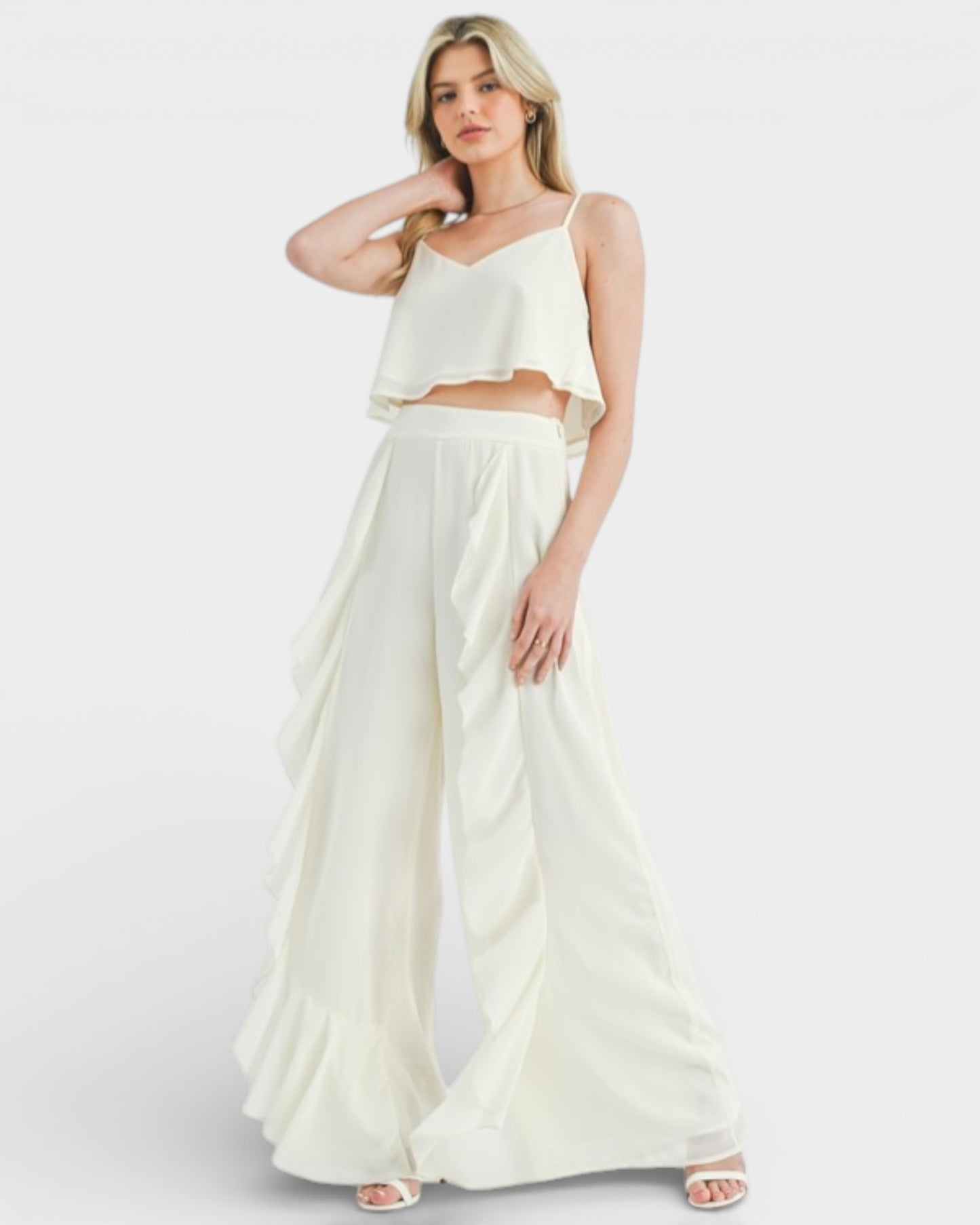 Woman wearing a white outfit on a plain background