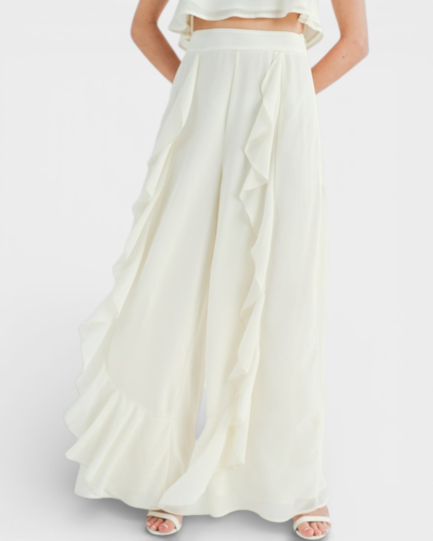 White two-piece outfit with a long skirt and top on a white background