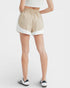 Beige shorts with white trim worn by a person on a white background