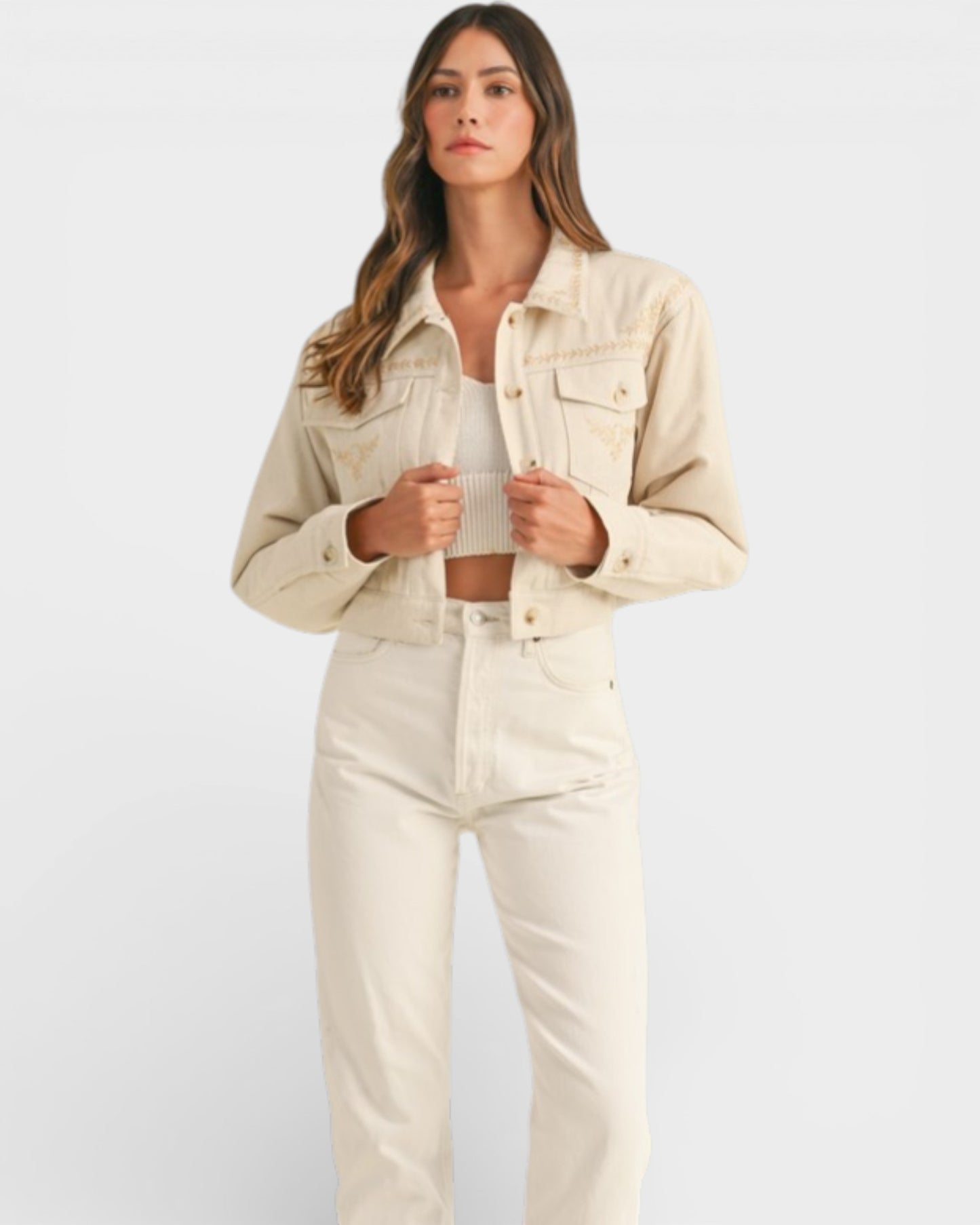 Woman wearing a beige denim jacket and pants on a white background
