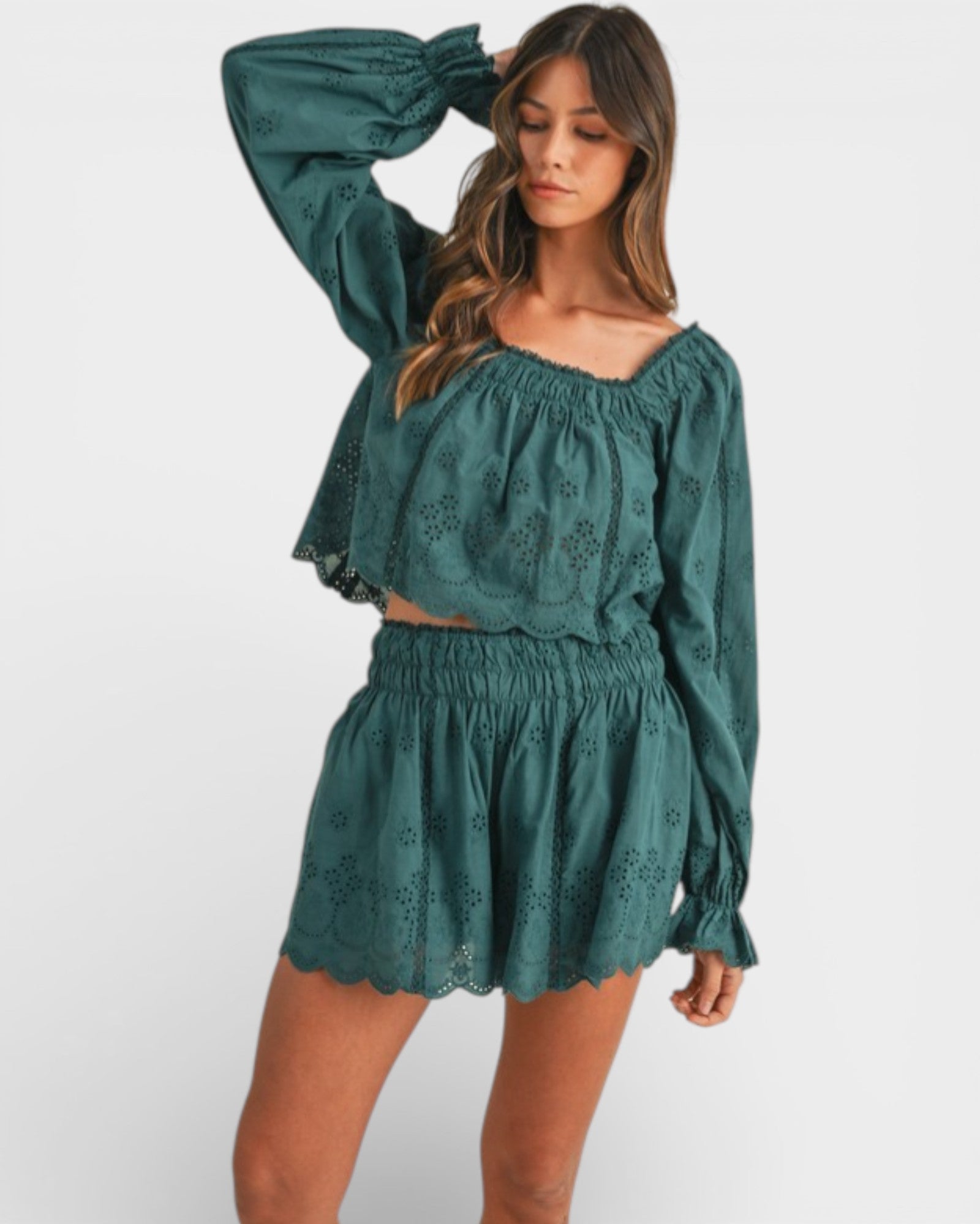 Woman wearing a green lace outfit on a white background