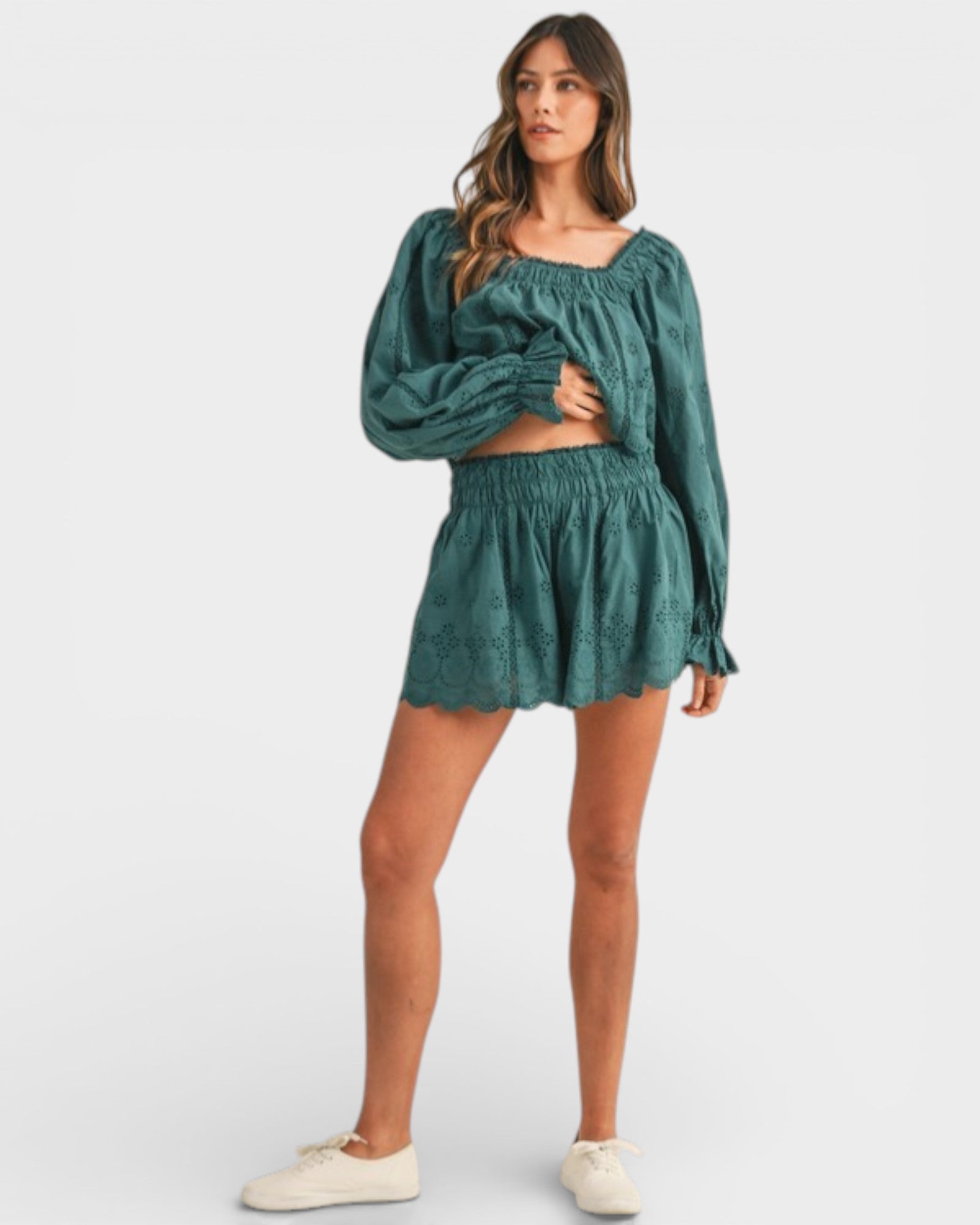 Woman wearing a green outfit on a white background