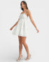 Woman wearing a white dress on a plain background