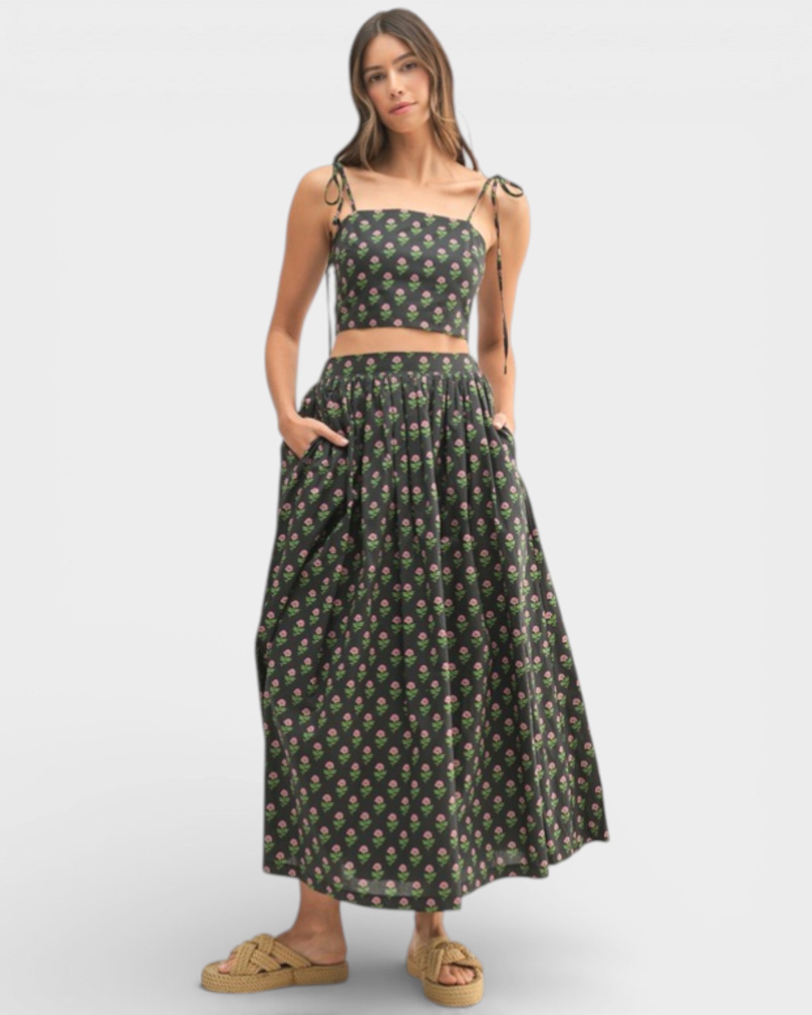 Woman wearing a floral two-piece outfit on a white background