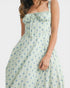 Woman wearing a floral dress with a white background