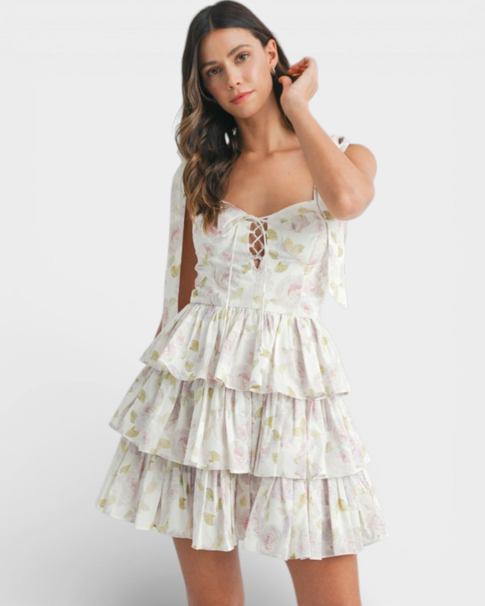 Woman wearing a white floral dress on a white background