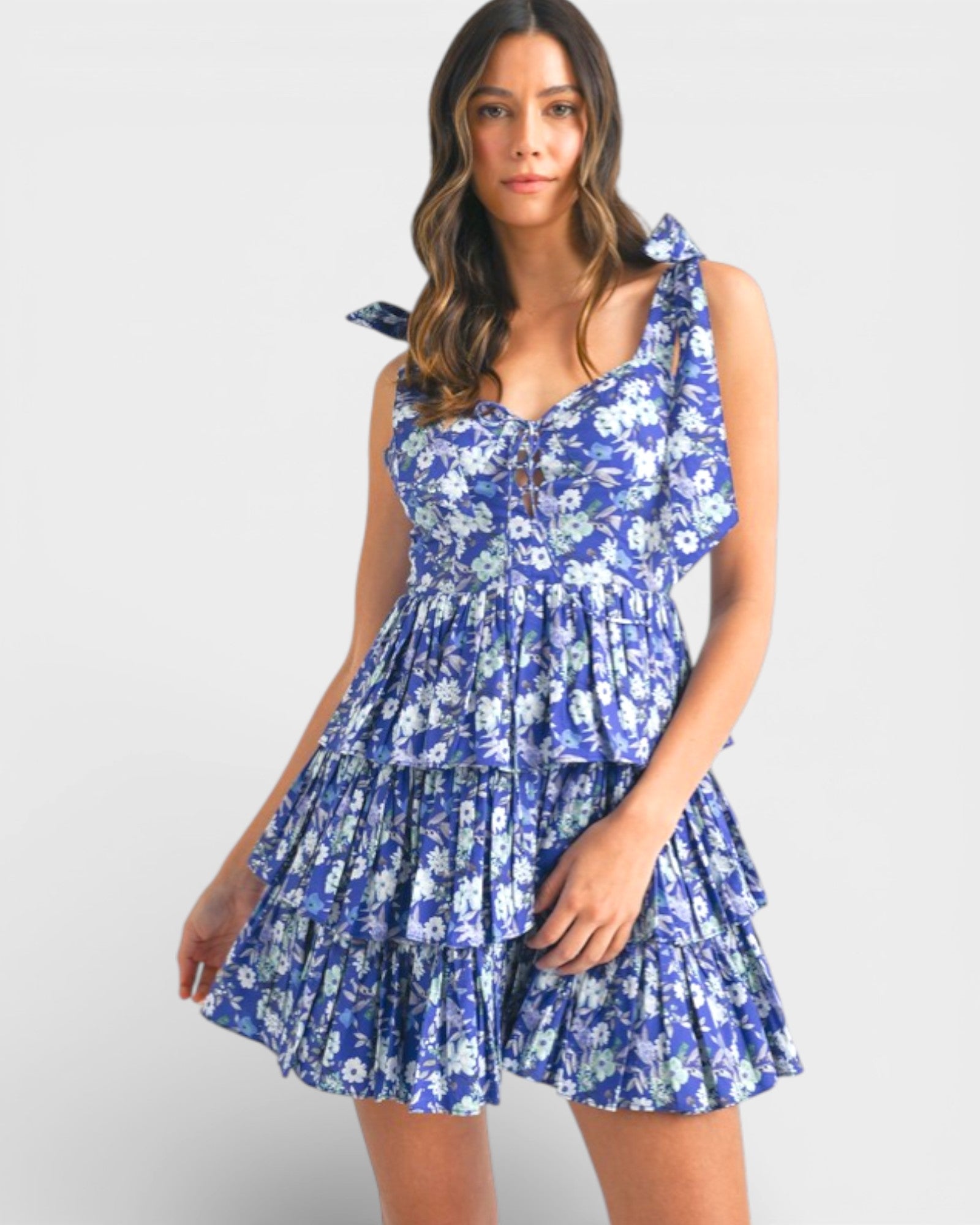 Woman wearing a blue floral dress on a white background