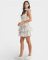 Woman wearing a floral tiered dress on a white background
