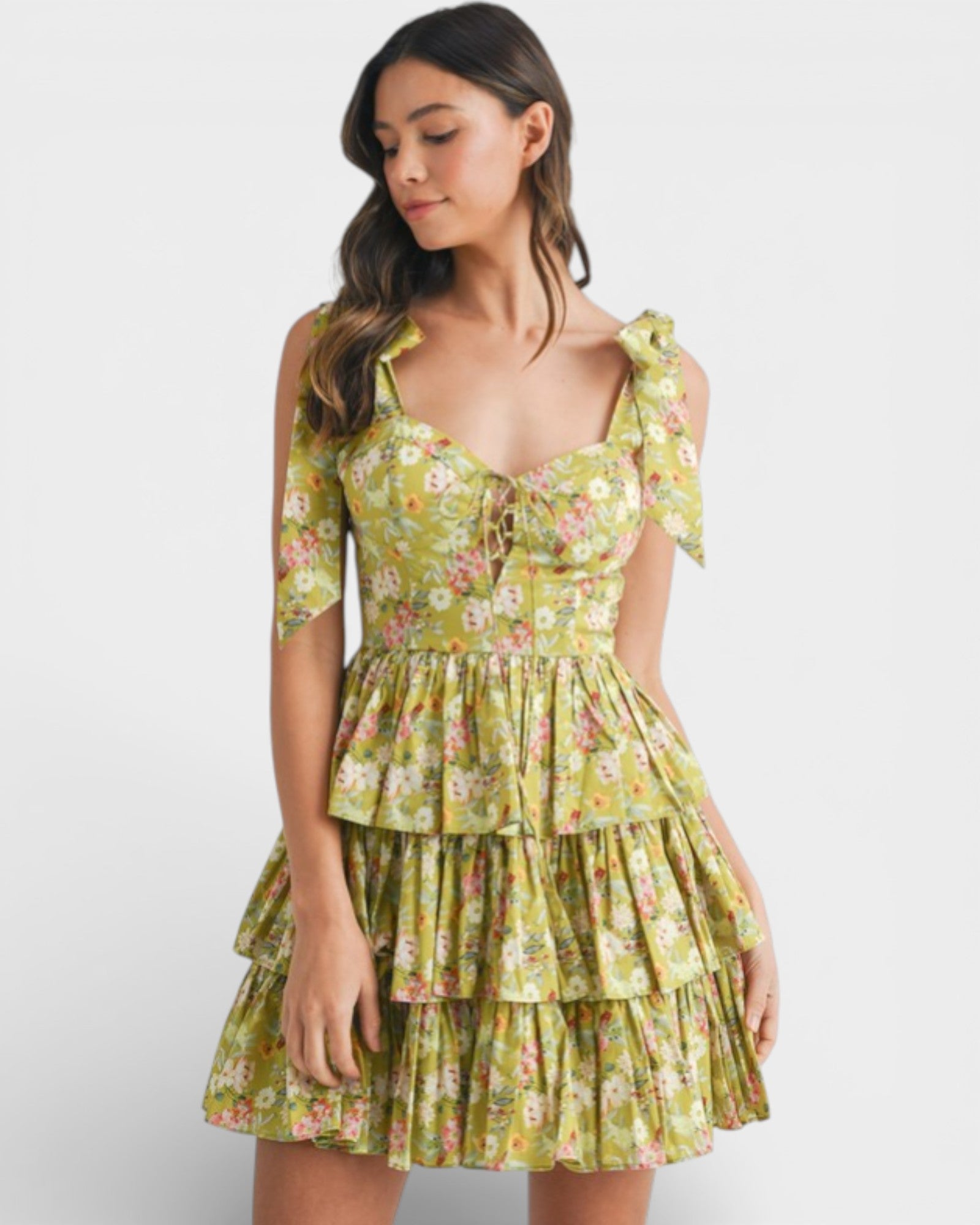 Woman wearing a yellow floral dress on a white background