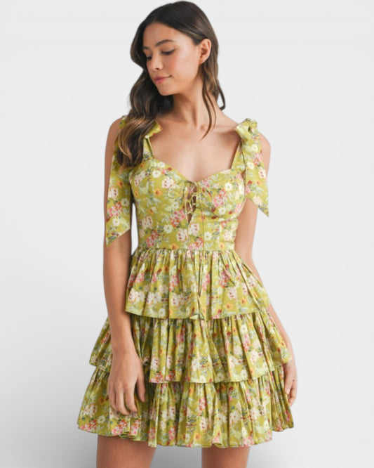 Woman wearing a yellow floral dress on a white background