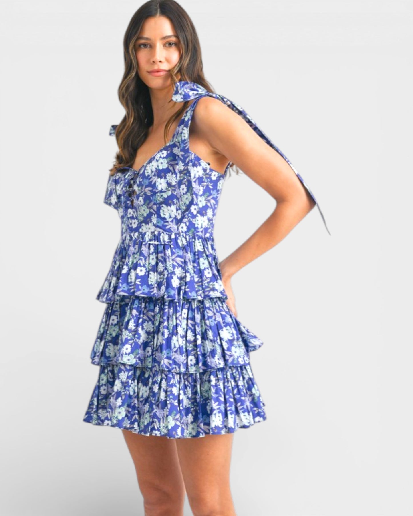 Woman wearing a blue floral dress on a white background