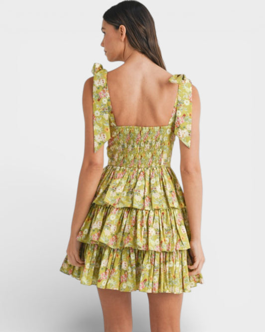 Woman wearing a green floral dress on a white background