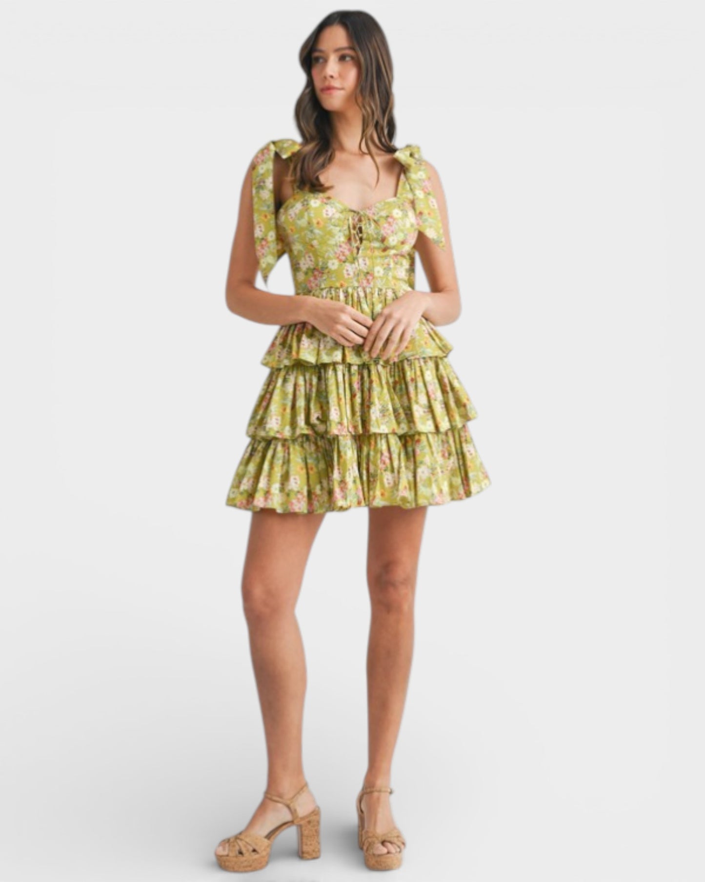 Woman wearing a yellow floral dress on a white background