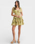 Woman wearing a yellow floral dress on a white background