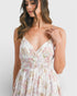 Woman wearing a floral dress against a white background