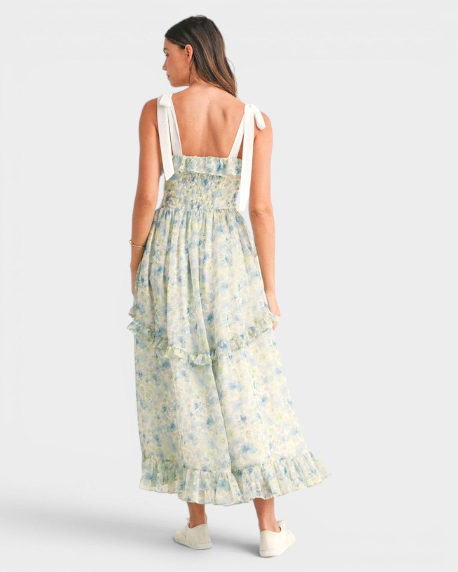 Woman wearing a floral dress on a white background