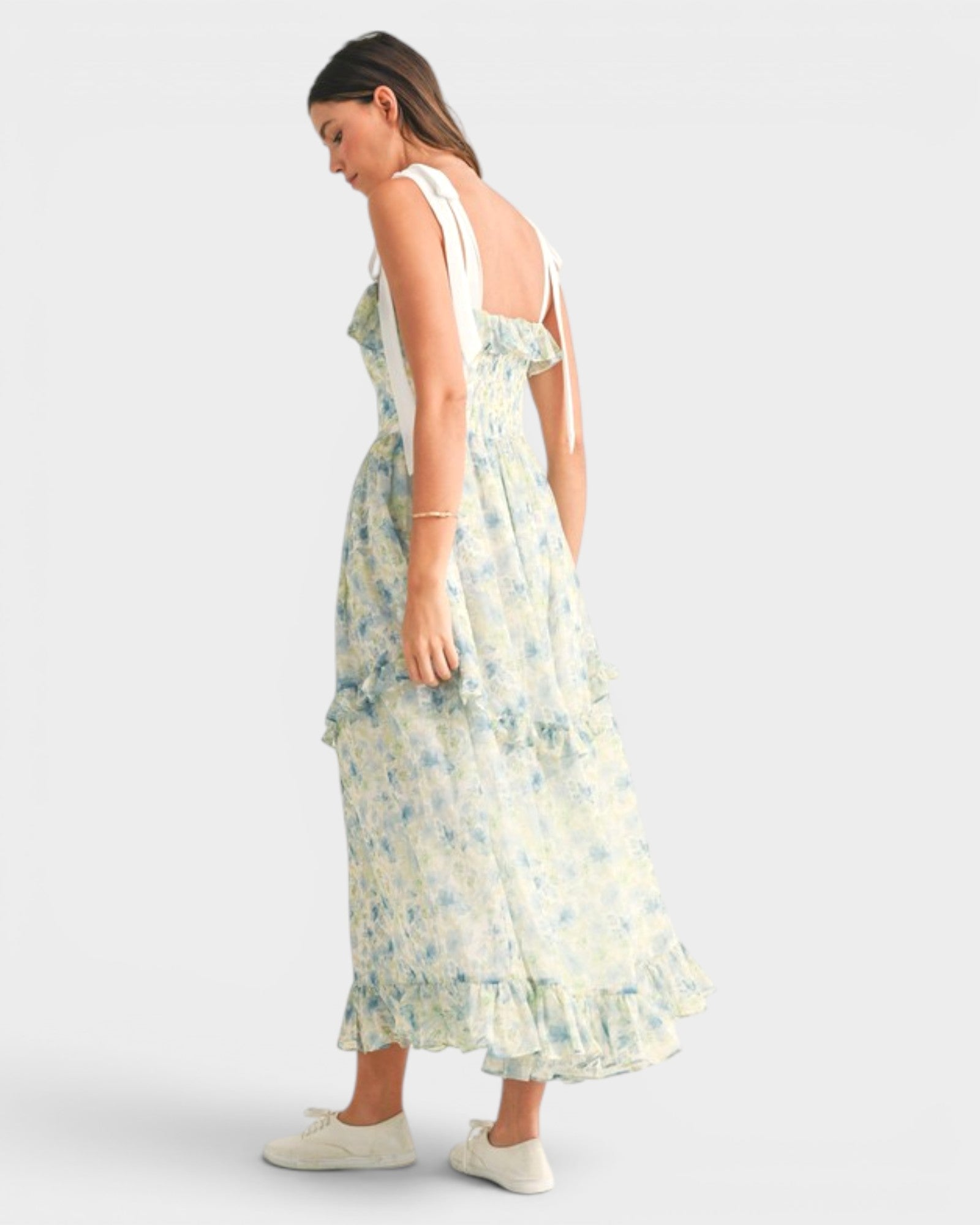 Woman wearing a floral dress on a white background