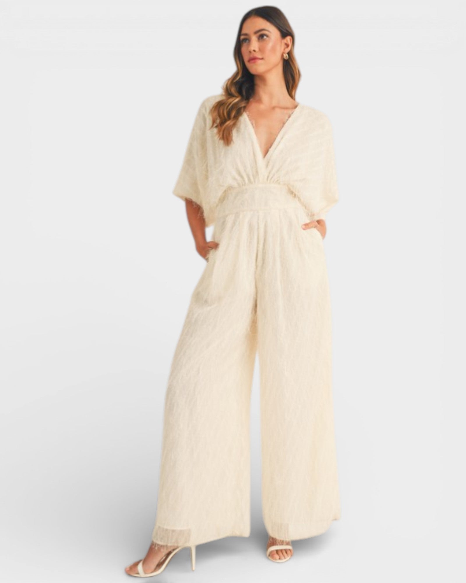 Woman wearing a beige jumpsuit on a white background