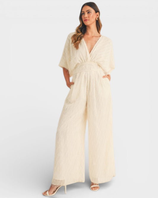 Woman wearing a beige jumpsuit on a white background