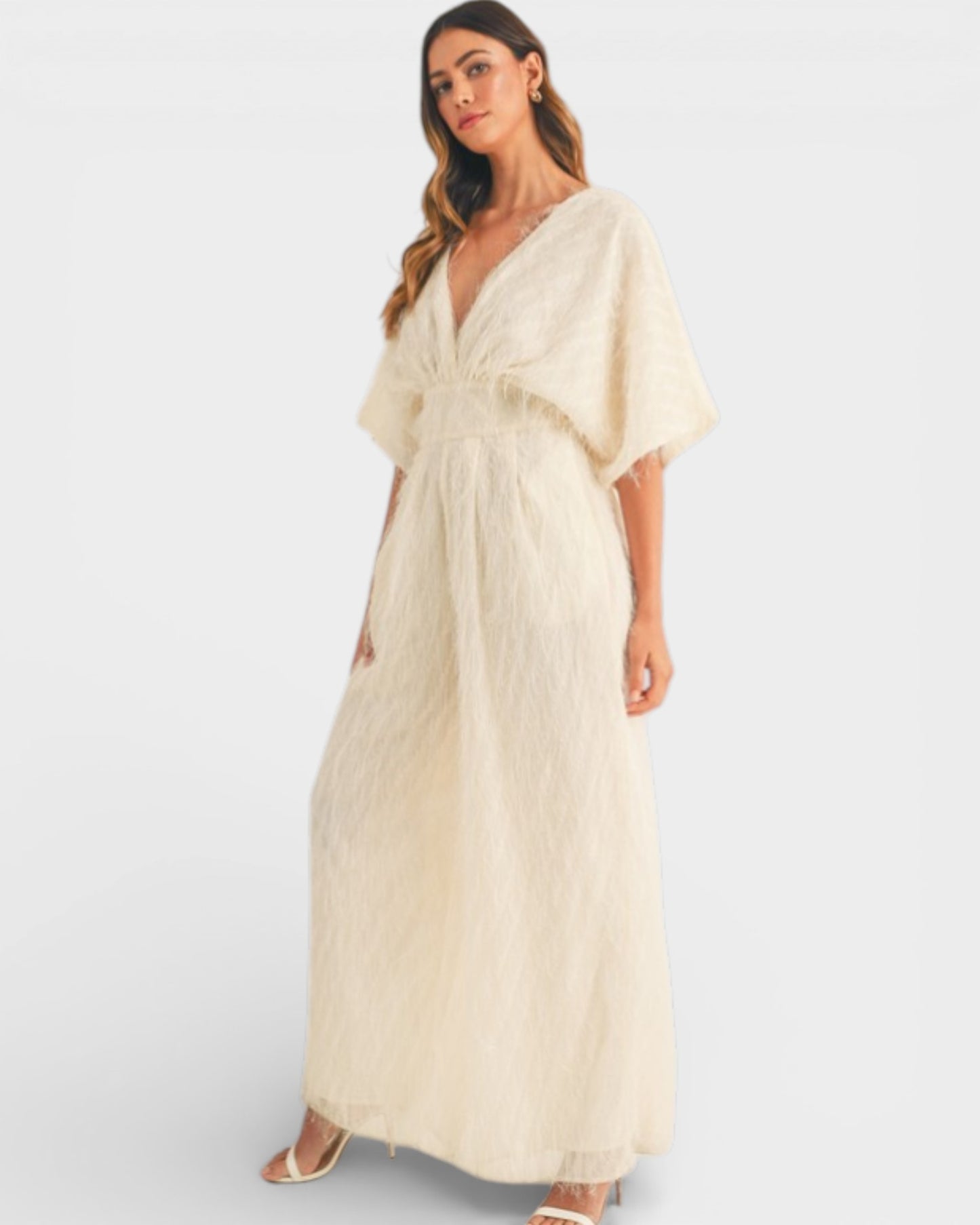 Woman wearing a beige dress on a white background