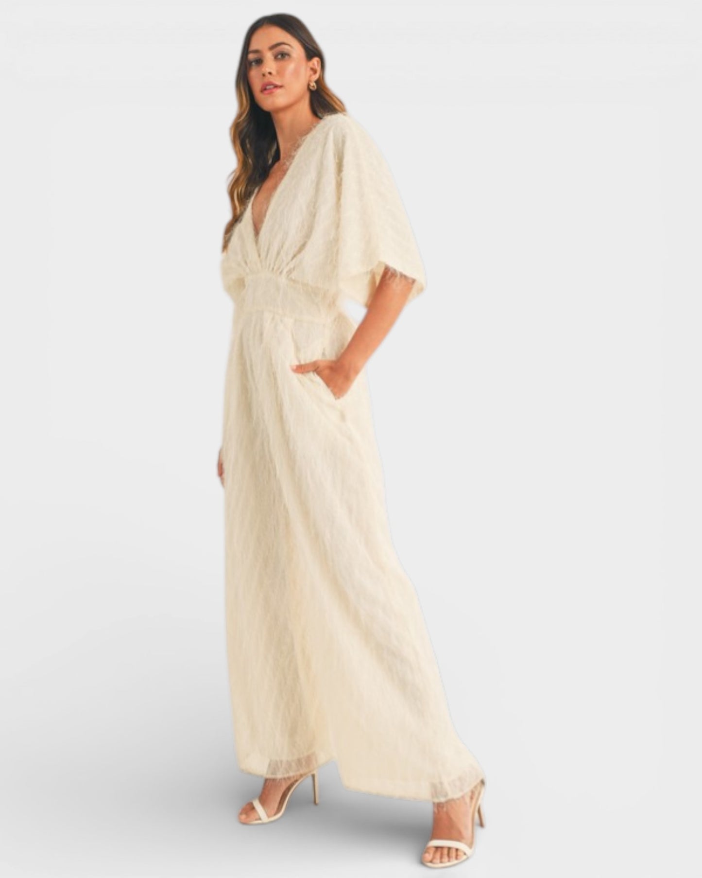 Woman wearing a beige dress on a white background