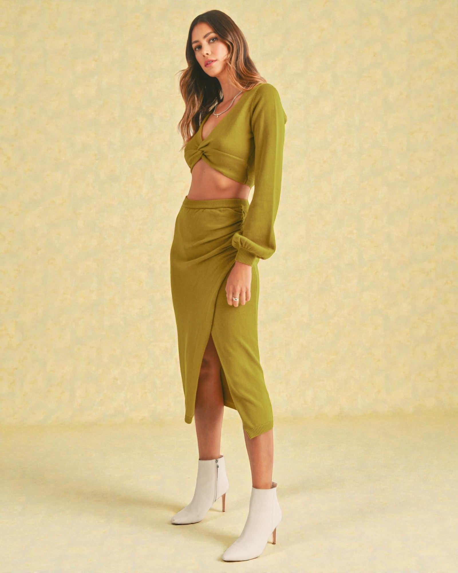 Woman wearing a green outfit with a yellow background