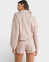 Woman wearing a light pink outfit on a white background