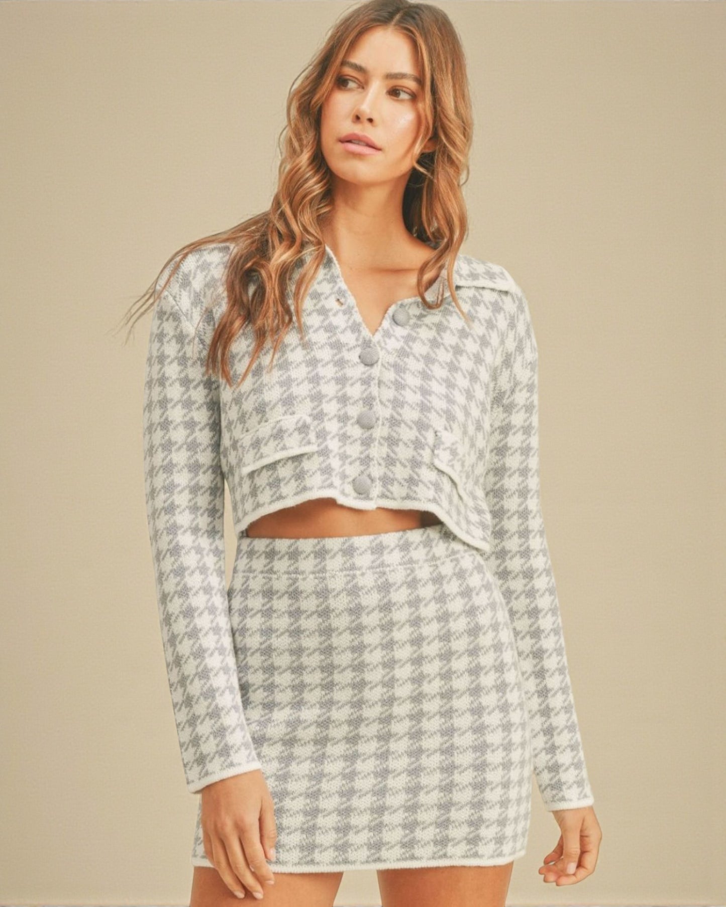 Woman wearing a patterned outfit on a beige background