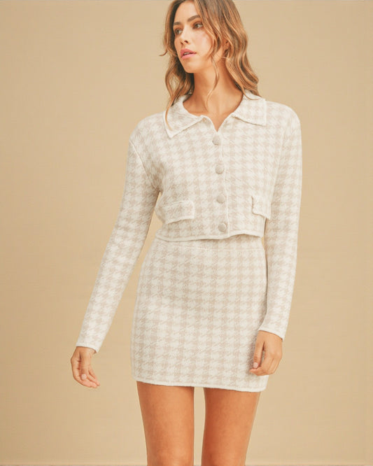 Woman wearing a white checkered outfit on a beige background