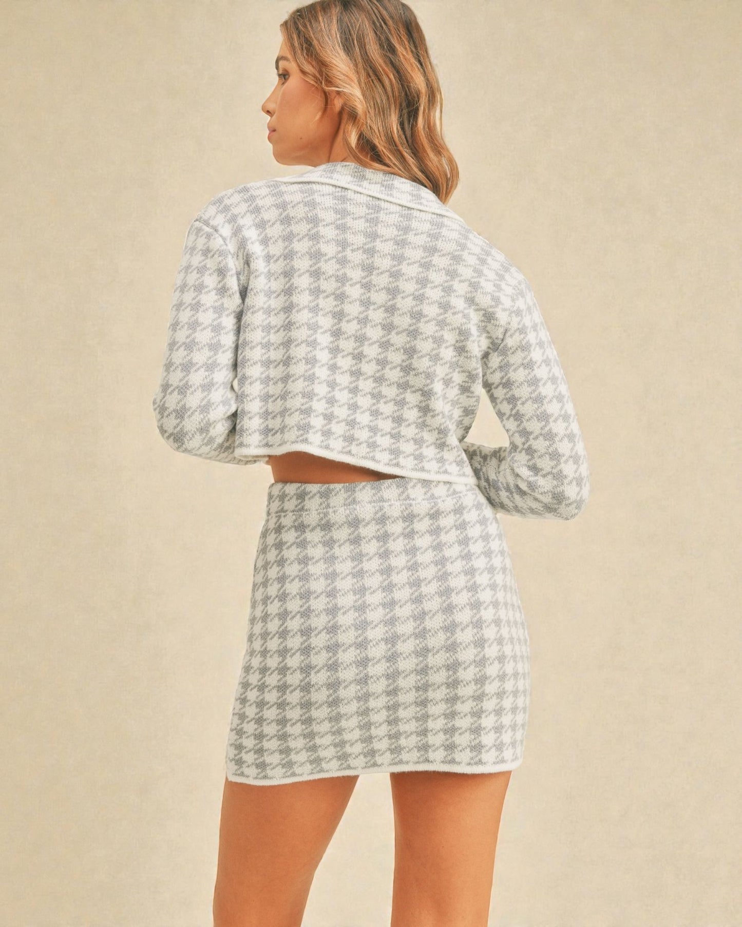 Woman wearing a matching checkered outfit on a beige background