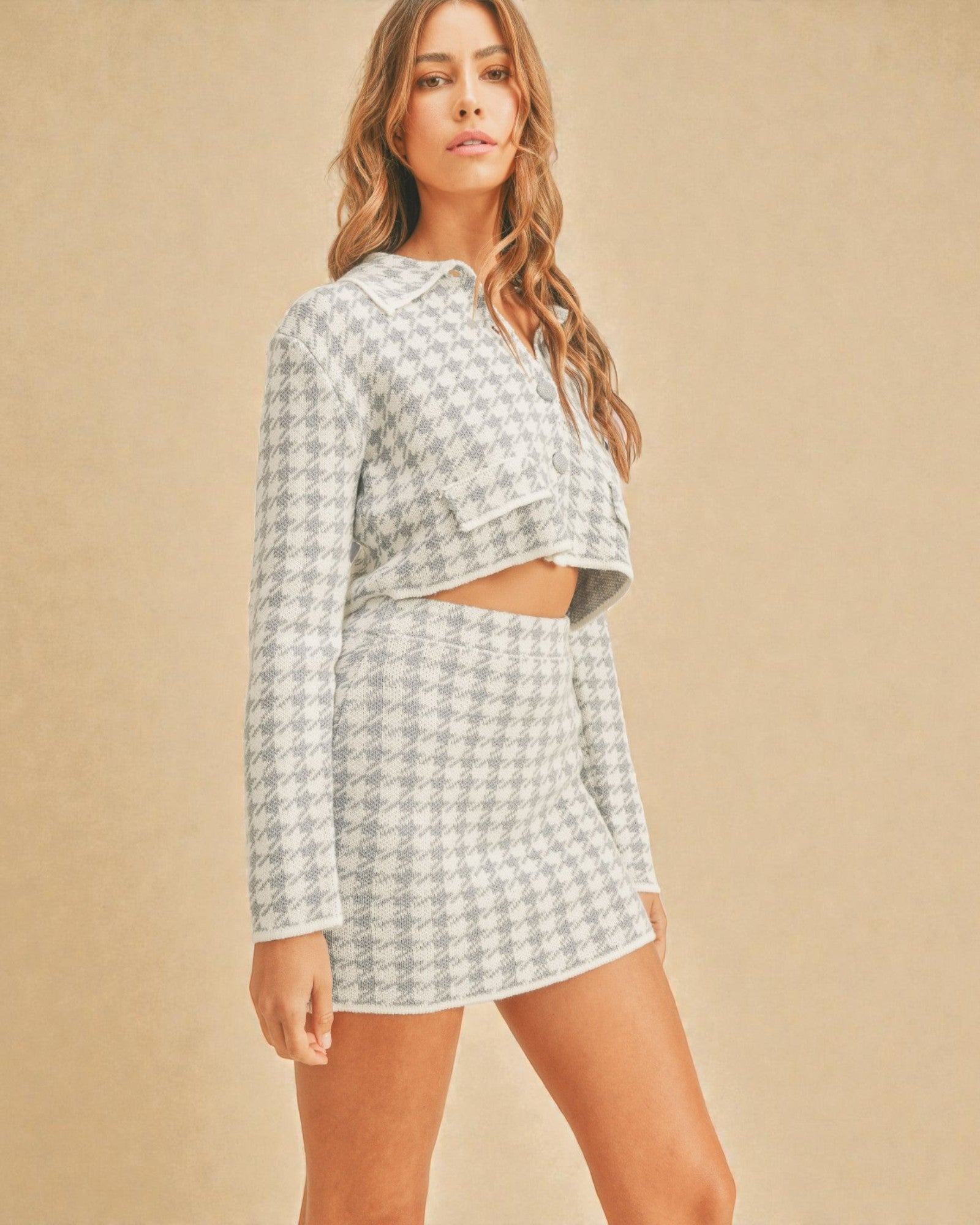 Woman wearing a patterned outfit against a beige background