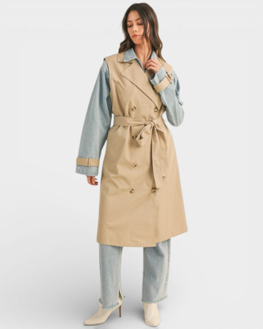 Woman wearing a beige trench coat with a white background