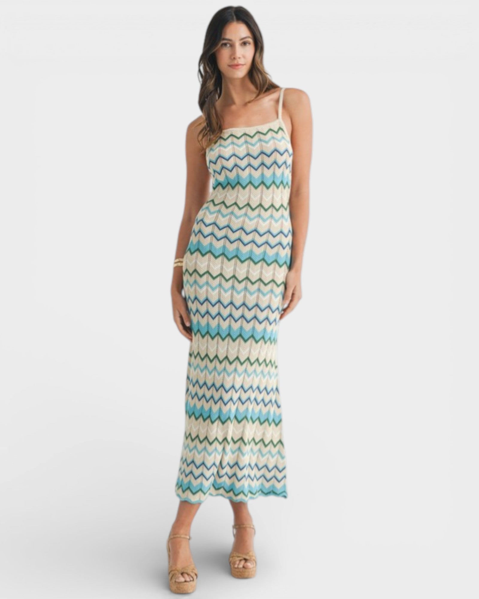 Woman wearing a patterned dress on a white background